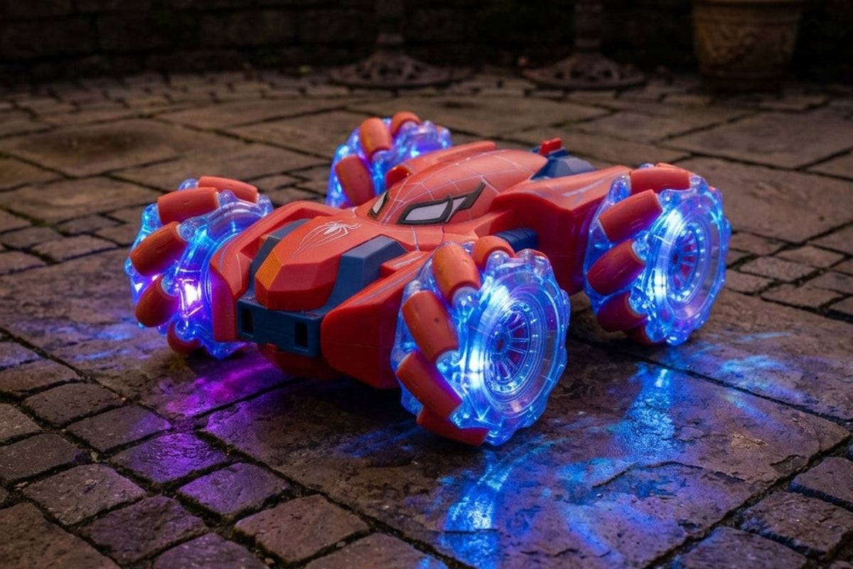 Voiture cascadeuse Arachno double face rouge, de face, sur une terrasse pavée la nuit, roues à LED allumées